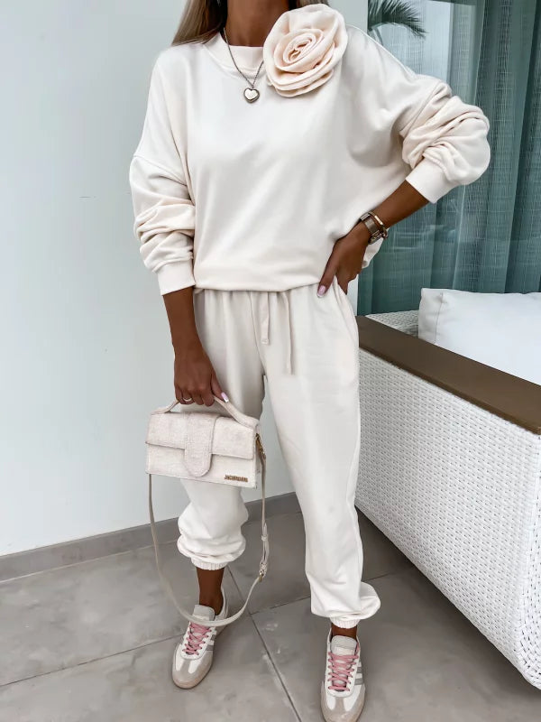 Άνετο ελαστικό σετ φόρμας με φούτερ oversized μακρυμάνικο με στρογγυλή λαιμόκοψη και παντελόνι φόρμας με λάστιχο στη μέση και τα πατζάκια.

